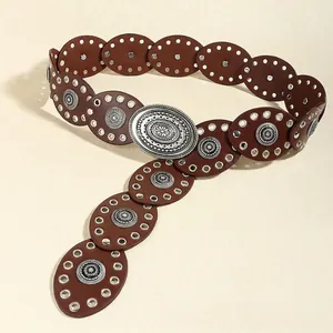 Close-up of bohemian brown leather belt with vintage floral engraved silver buckle