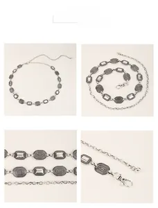 Macro detail of vintage silver metal chain belt with embossed textures and lobster clasp