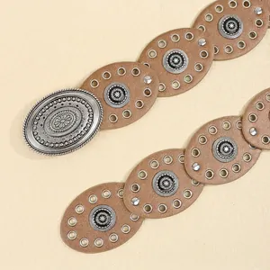 Close-up of bohemian belt with silver vintage embossed metal buckle and leather segments