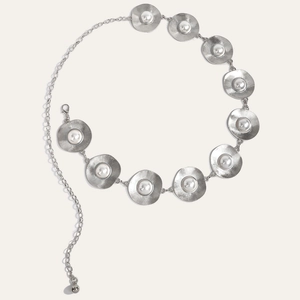 Silver metal chain belt with radial textured discs and white pearl center accents