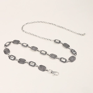 Detailed close-up of retro silver metal waist chain with lobster clasp and textured links