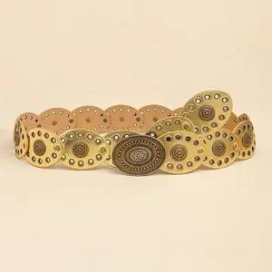 Detail of bohemian gold metal belt featuring sunburst embossing and hollow-out oval links