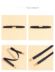 Detail view of black elastic belt with gold metal hook buckle and lychee leather accents