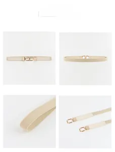 Detail view of beige elastic waist belt with gold interlocking buckle and woven texture