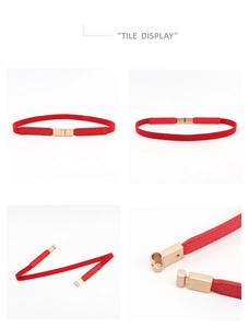 Detail view of a thin red elastic waist belt with a gold interlocking metal buckle