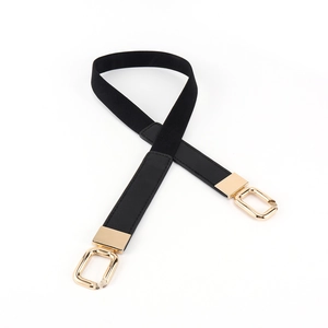Close-up of black elastic belt with gold metal buckles and leather finish for dresses