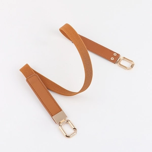 Close-up of brown elastic waist belt with premium light brown leather and gold buckle
