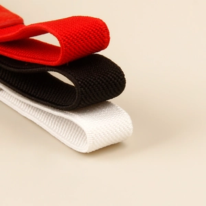 Detailed macro view of elastic knitted belts in red, black and white textured fabric