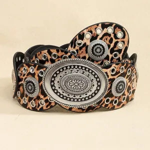 Detail of wide leopard print belt featuring vintage silver buckle and metal eyelets