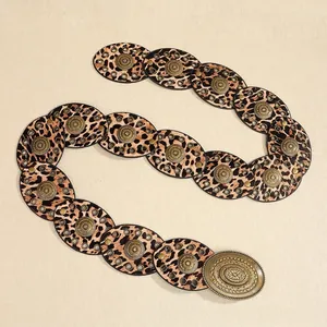 Detail of leopard print link belt with vintage sunburst buckle in western style