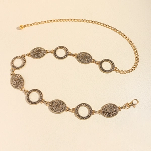 Close-up of golden vintage waist chain with embossed oval links and lobster clasp