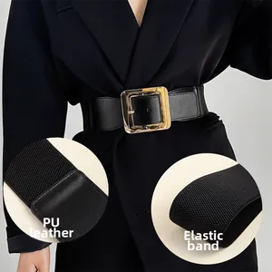 Détail d'une large ceinture élastique noire avec une grande boucle carrée en métal doré