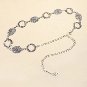Detailed macro view of vintage silver embossed metal chain belt with lobster clasp and beads