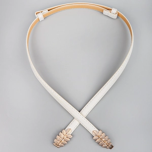 Detail of white PU leather belt with decorative gold leaf buckle for women fashion