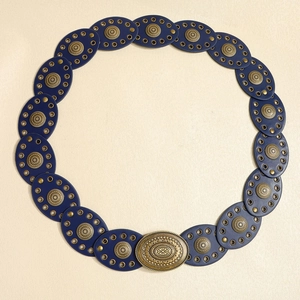 Detail of bohemian punk belt with blue leather oval links and embossed bronze metal discs
