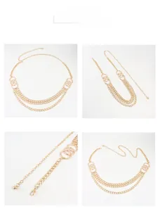 Detail view of multi-layer golden waist chain with round ring connectors and lobster clasp