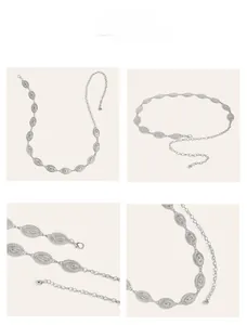 Close-up of vintage geometric engraved silver metal waist chain with lobster clasp and texture