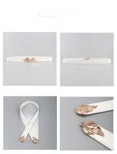 Detail view of thin white elastic waist belt with a golden leaf-shaped buckle closure