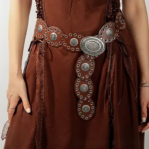 Close-up of bohemian leather belt with metal conchos and oval buckle on brown lace dress