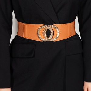 Close-up of brown elastic waist belt with sparkling rhinestone double circle metal buckle