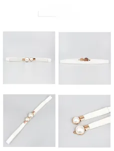 Close-up of elegant white leather belt with gold buckle and pearl decoration
