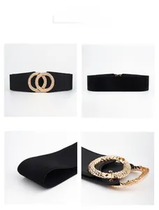 Detail view of black elastic belt with textured gold interlaced double ring buckle