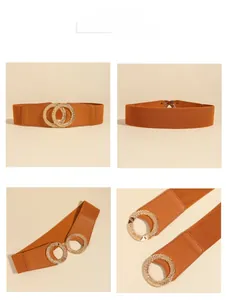 Detailed view of caramel elastic waist belt featuring a textured golden double ring buckle