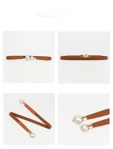 Detail view of brown elastic waist belt with elegant pearl buckle for dresses
