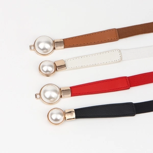 Detail of four elastic waist belts with large pearl gold buckles in various colors