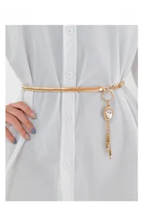 Detail of gold metal waist belt with rhinestone fringe charms on a white shirt