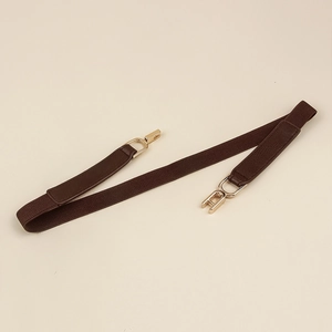 Detail of coffee brown elastic belt featuring textured leather ends and gold metal hooks