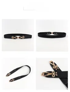 Macro detail of elastic black waist belt featuring a gold-tone hollow streamlined metal buckle