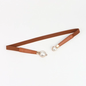 Close-up of brown elastic waist belt featuring elegant double white pearl buckle decor