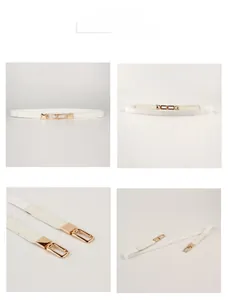 Detail of white elastic dress belt featuring a modern gold interlocking double ring buckle