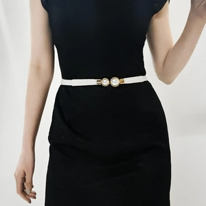 Elegant white skinny waist belt with gold pearl buckle on a black dress accessory