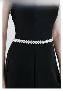 Détail d'une ceinture de taille en perles à double rangée avec boucle de nœud dorée et cristaux