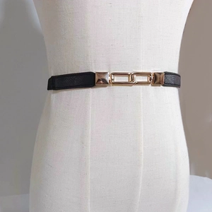 Minimalist black elastic dress belt for women with interlocking gold geometric metal buckle