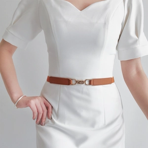 Elegant thin brown elastic waist belt for women featuring a gold circular metal buckle