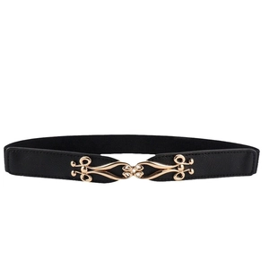 Women's slim elastic black waist belt with decorative golden metal buckle closure