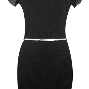 Close-up of minimalist silver metal waist chain with rectangular buckle on black dress