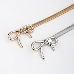 Detail of gold and silver bow buckle elastic metal waist chains for dresses