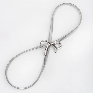 Close-up of shiny silver bow buckle and elastic metal spring texture on waist chain