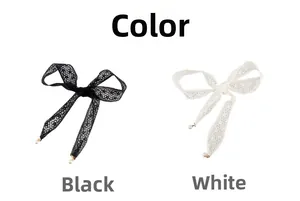Detailed close-up of lace bow belts in black and white with elegant pearl pendants
