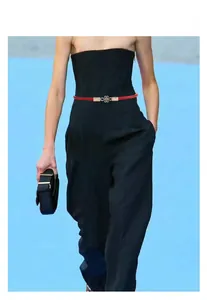 Thin red PU leather waist belt for women with a golden infinity knot buckle detail