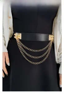 Close-up of black elastic waist belt with gold square buckle and triple layered chains