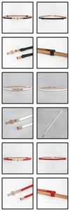 Macro detail of adjustable PU leather belts with decorative gold metal buckles in three colors