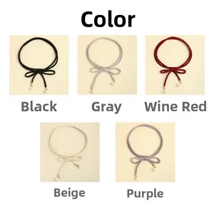 Detail view of thin velvet waist belts with pearls in black, burgundy, beige and purple