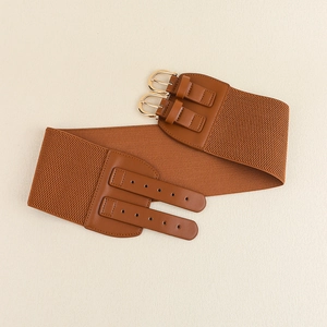 Close-up of brown elastic wide waist belt featuring a double metal buckle design on beige texture