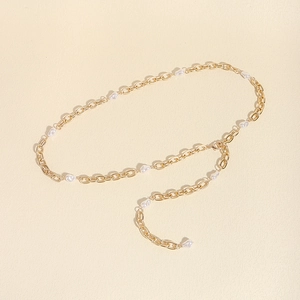Detail of elegant gold metal waist chain with baroque pearls for dresses and outfits