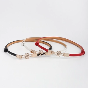 Three-piece set of slim PU leather belts for women in black, white, and red with gold buckles